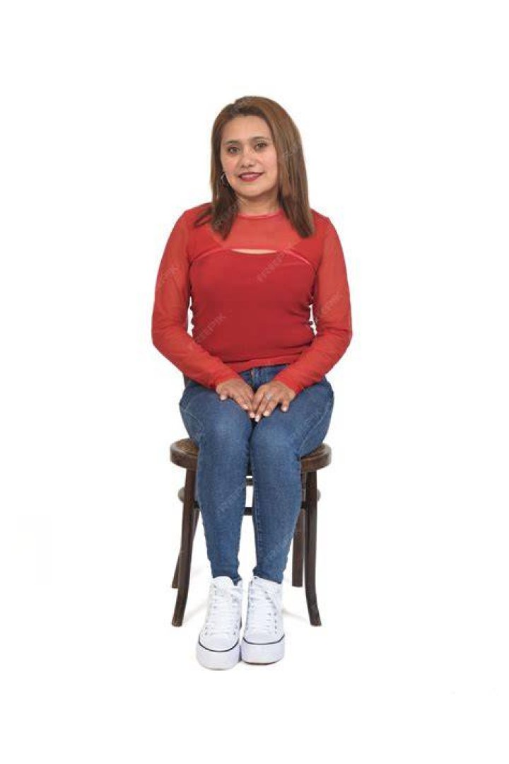a woman sitting in front of a computer screen with a ring on her left hand