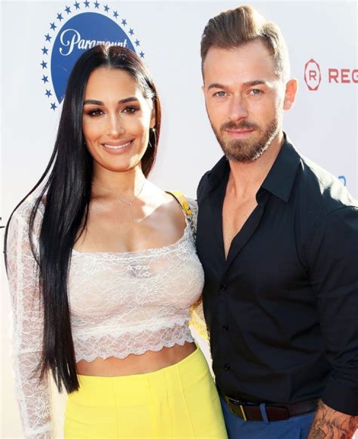 Nikki Bella and boyfriend Artem Chigvintsev pack on some PDA while out